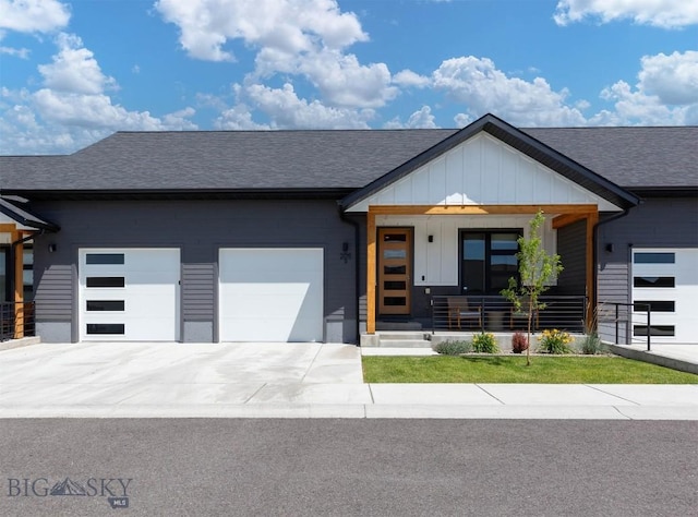 205 Albrey Trl Unit B, Bozeman, MT 59718 - view of front of property with an attached garage, a shingled roof, board and batten siding, and a porch