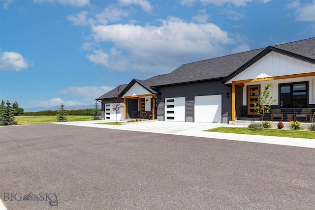 205 Albrey Trl Unit B, Bozeman, MT 59718 - modern farmhouse style home with a garage, covered porch, concrete driveway, roof with shingles, and board and batten siding