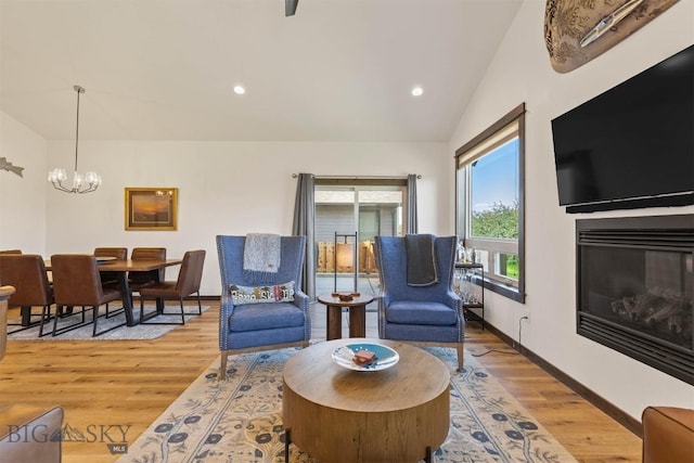 205 Albrey Trl Unit B, Bozeman, MT 59718 - living room with a chandelier, a glass covered fireplace, light wood-style flooring, vaulted ceiling, and recessed lighting