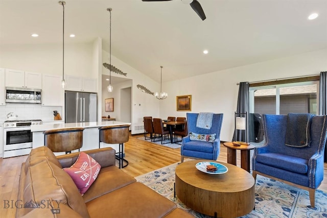 205 Albrey Trl Unit B, Bozeman, MT 59718 - living area with light wood finished floors, a ceiling fan, recessed lighting, high vaulted ceiling, and a chandelier