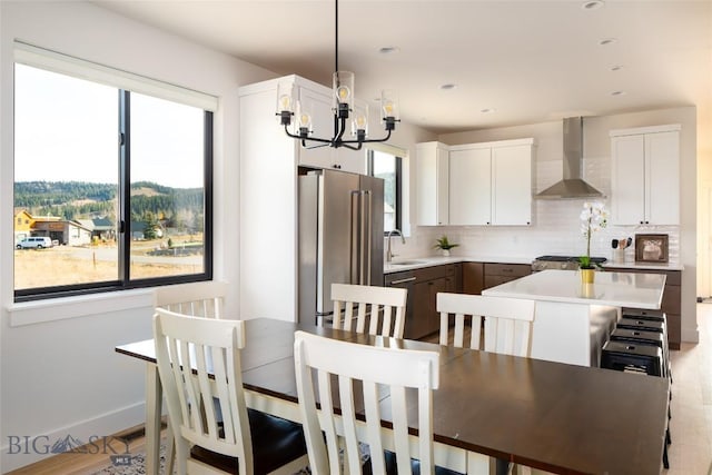 87 Upper Whitefish Dr, Big Sky, MT 59716 - dining space featuring a chandelier, healthy amount of natural light, and light wood finished floors