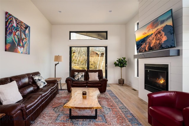 87 Upper Whitefish Dr, Big Sky, MT 59716 - living area featuring wood finished floors and a large fireplace