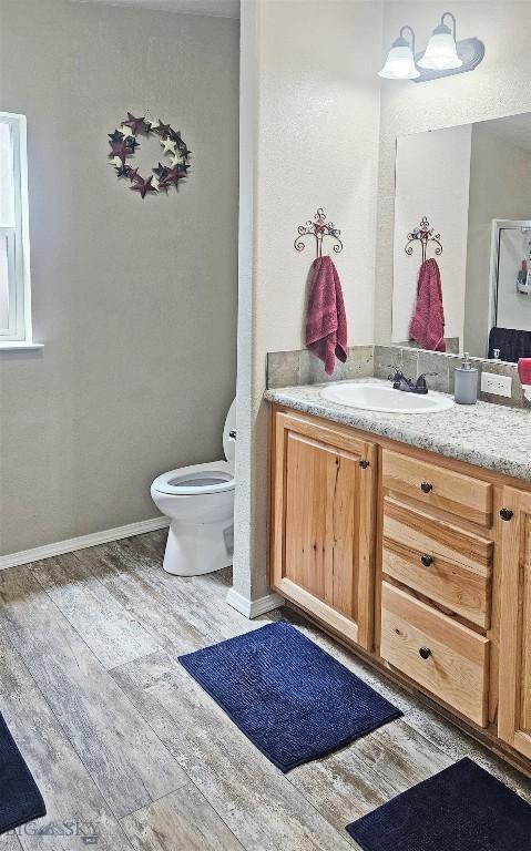 950 N Harrison St, Lima, MT 59739 - half bathroom with wood finished floors and vanity