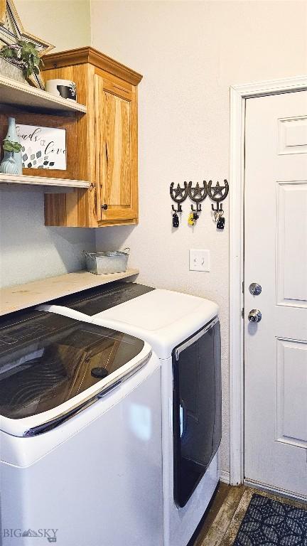 950 N Harrison St, Lima, MT 59739 - laundry area featuring separate washer and dryer, cabinet space, and wood finished floors