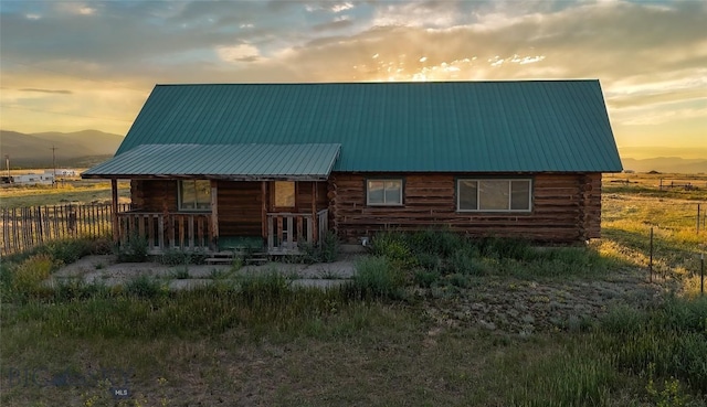 7223 Birdseye Rd, Helena, MT 59602 - view of front of home featuring covered porch, a mountain view, log exterior, and a metal roof
