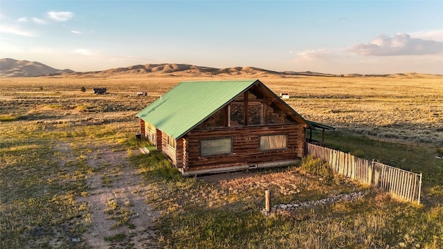 7223 Birdseye Rd, Helena, MT 59602 - view of front of house featuring log siding, a mountain view, a metal roof, and a view of countryside