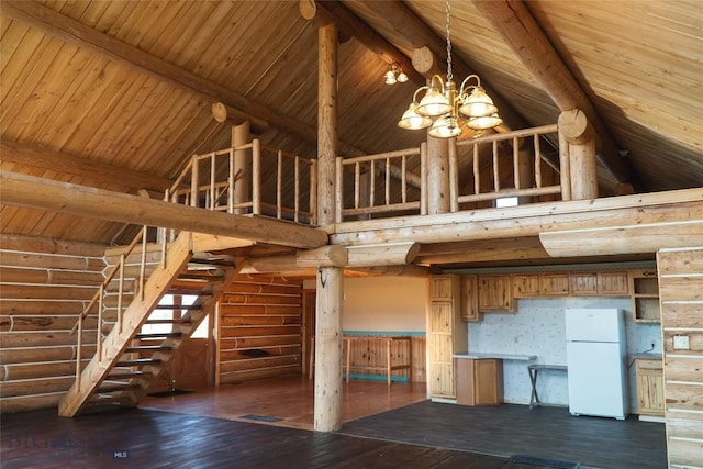 7223 Birdseye Rd, Helena, MT 59602 - unfurnished living room featuring a chandelier, dark wood finished floors, rustic walls, high vaulted ceiling, and a wood ceiling with exposed beams