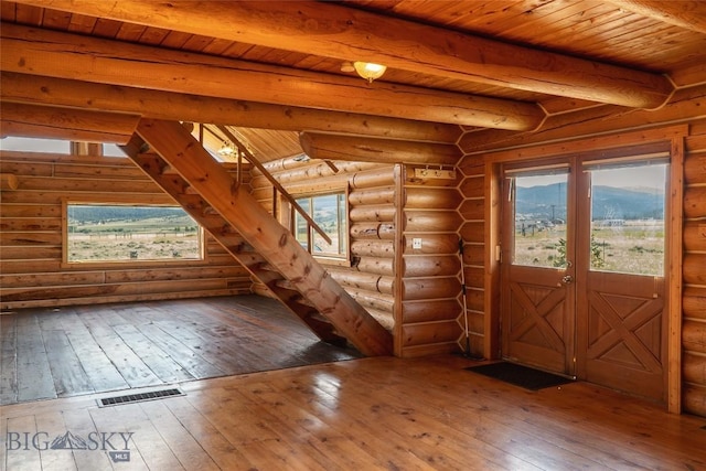 7223 Birdseye Rd, Helena, MT 59602 - foyer featuring hardwood / wood-style floors, a wood ceiling with exposed beams, log walls, and stairs