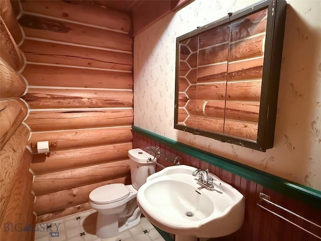 7223 Birdseye Rd, Helena, MT 59602 - bathroom with rustic walls, a wainscoted wall, and wallpapered walls
