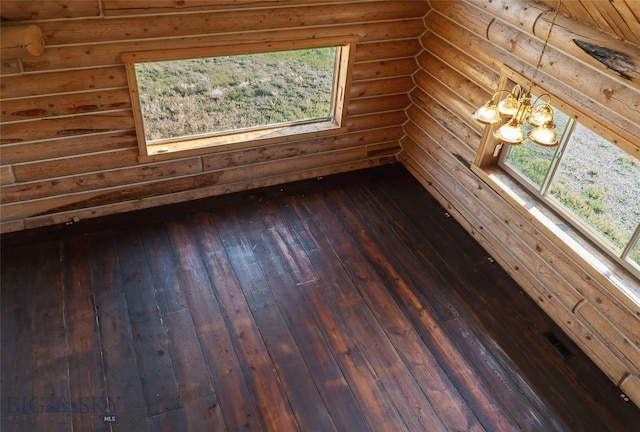 7223 Birdseye Rd, Helena, MT 59602 - empty room with a chandelier, log walls, and dark wood-style flooring