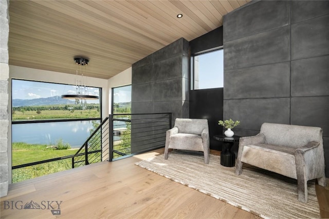 240 Horsetail Rd, Bozeman, MT 59715 - sitting room with wood finished floors, lofted ceiling, wood ceiling, and a water view