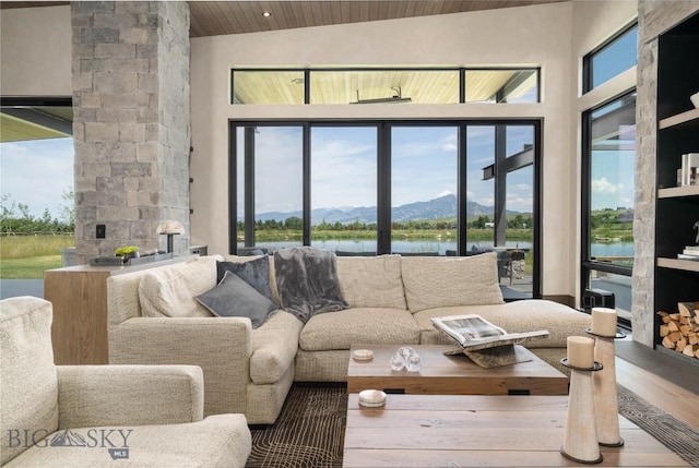 240 Horsetail Rd, Bozeman, MT 59715 - living area with wood ceiling, a water and mountain view, wood finished floors, and a towering ceiling