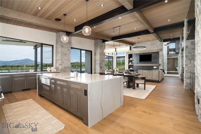 240 Horsetail Rd, Bozeman, MT 59715 - kitchen with a wooden ceiling with exposed beams, light wood-style floors, decorative light fixtures, open floor plan, and an island with sink