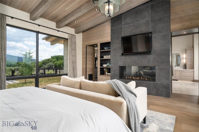 240 Horsetail Rd, Bozeman, MT 59715 - bedroom featuring wood finished floors, wooden ceiling, ensuite bathroom, wooden walls, and access to exterior