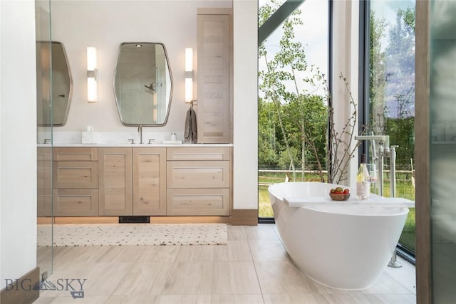 240 Horsetail Rd, Bozeman, MT 59715 - full bathroom featuring a freestanding bath, vanity, and tile patterned flooring