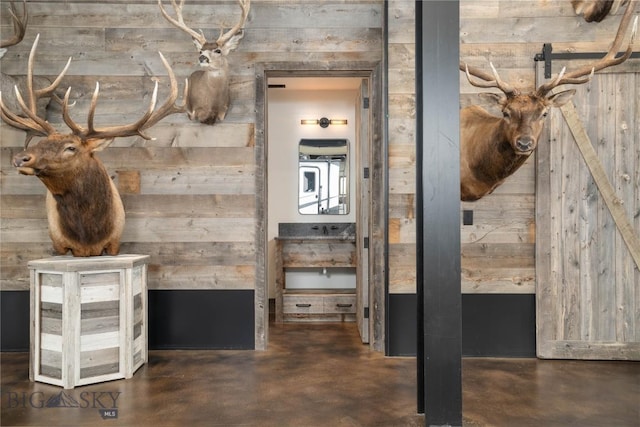 240 Horsetail Rd, Bozeman, MT 59715 - hall featuring wood walls and finished concrete flooring