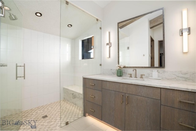 240 Horsetail Rd, Bozeman, MT 59715 - full bath featuring a shower stall, vanity, vaulted ceiling, and tile patterned flooring