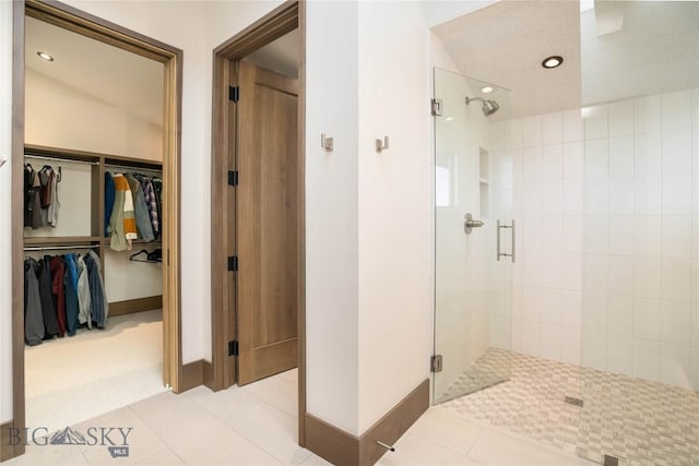 240 Horsetail Rd, Bozeman, MT 59715 - bathroom featuring a shower stall, a walk in closet, tile patterned floors, and recessed lighting
