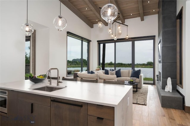 240 Horsetail Rd, Bozeman, MT 59715 - kitchen with wooden ceiling, light countertops, light wood finished floors, a water view, and healthy amount of natural light