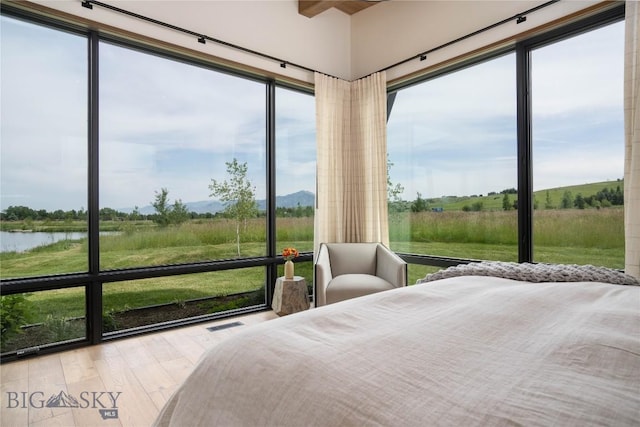 240 Horsetail Rd, Bozeman, MT 59715 - bedroom with wood finished floors and a water view