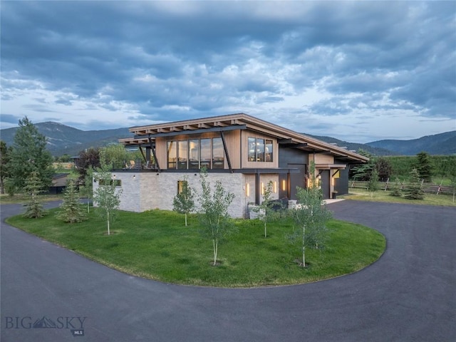 240 Horsetail Rd, Bozeman, MT 59715 - contemporary home with a mountain view, a garage, driveway, and a front yard