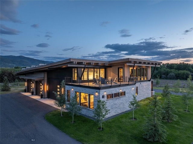 240 Horsetail Rd, Bozeman, MT 59715 - back of property with a balcony, driveway, and an attached garage
