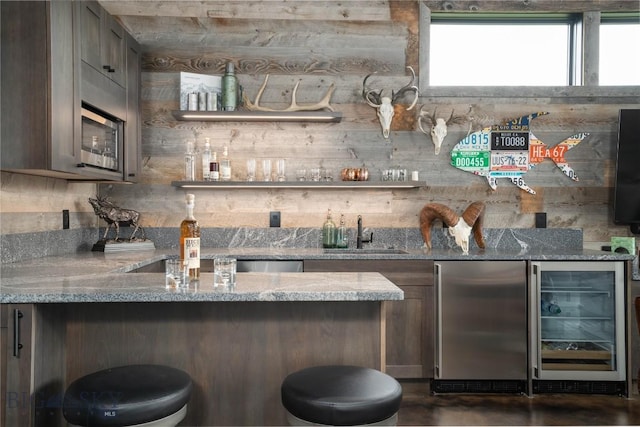 240 Horsetail Rd, Bozeman, MT 59715 - indoor wet bar featuring wine cooler, fridge, stainless steel microwave, and concrete flooring