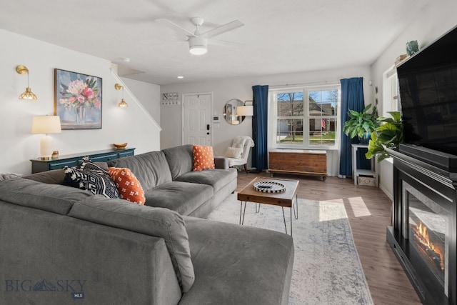 119 Meadow Brook Ln, Belgrade, MT 59714 - living room with wood finished floors, ceiling fan, and a glass covered fireplace