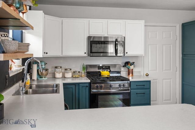 119 Meadow Brook Ln, Belgrade, MT 59714 - kitchen with appliances with stainless steel finishes, light countertops, white cabinets, and ventilation hood