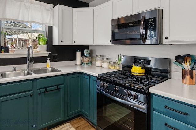 119 Meadow Brook Ln, Belgrade, MT 59714 - kitchen with stainless steel appliances, light countertops, and white cabinets