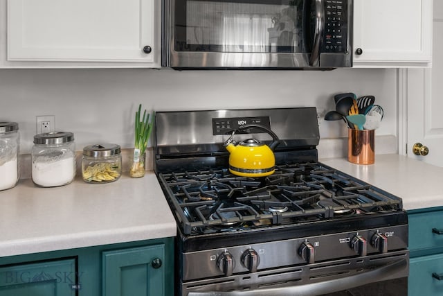 119 Meadow Brook Ln, Belgrade, MT 59714 - kitchen featuring stainless steel appliances, white cabinets, and light countertops