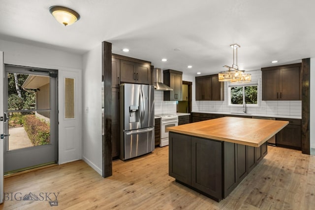 840 Damarell Rd, Bozeman, MT 59718 - kitchen featuring stainless steel fridge with ice dispenser, white electric stove, wall chimney range hood, wood counters, and dark brown cabinets