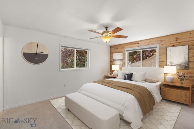 840 Damarell Rd, Bozeman, MT 59718 - bedroom featuring wooden walls, light carpet, and ceiling fan