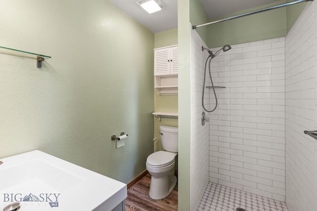 840 Damarell Rd, Bozeman, MT 59718 - full bath featuring vanity, tiled shower, and wood finished floors