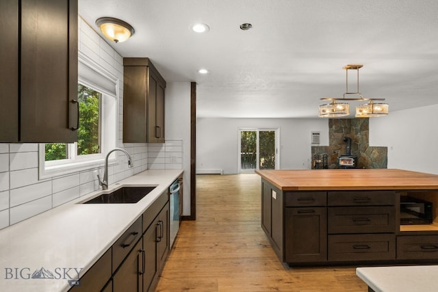 840 Damarell Rd, Bozeman, MT 59718 - kitchen featuring wood counters, open floor plan, backsplash, dishwasher, and light wood-style flooring