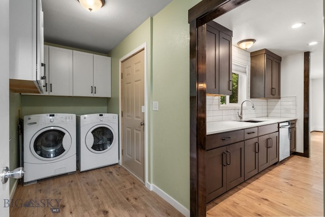 840 Damarell Rd, Bozeman, MT 59718 - laundry area with cabinet space, washer and clothes dryer, and light wood-style floors