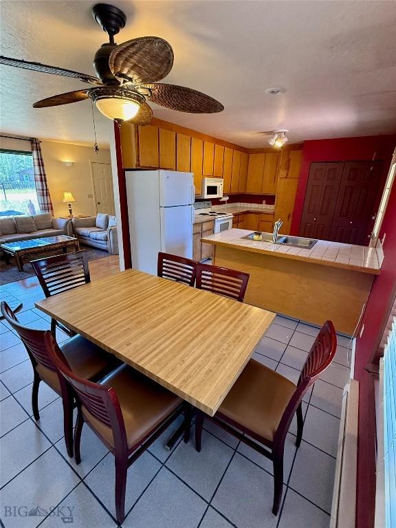 1364 Mcclellan Rd, West Yellowstone, MT 59758 - dining area featuring light tile patterned floors and a ceiling fan