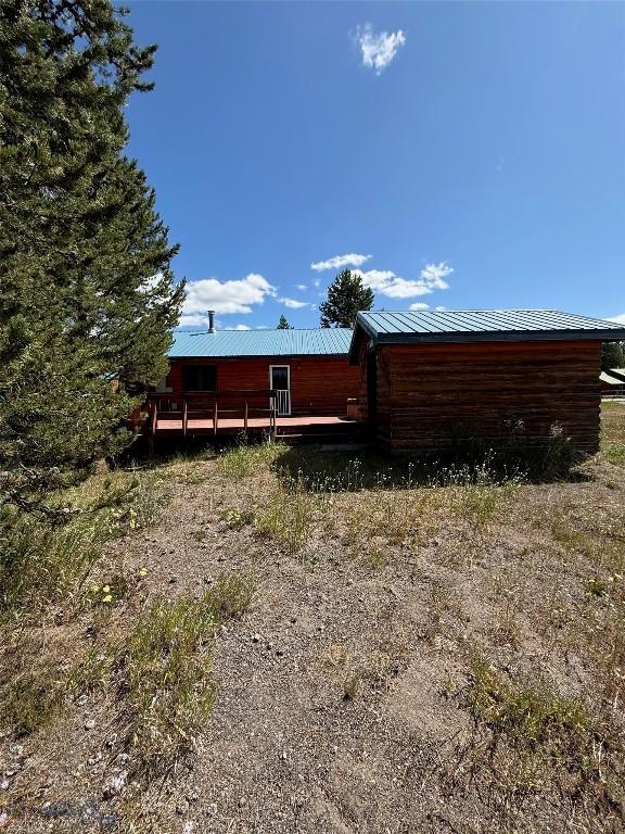 1364 Mcclellan Rd, West Yellowstone, MT 59758 - back of house featuring a deck and a metal roof