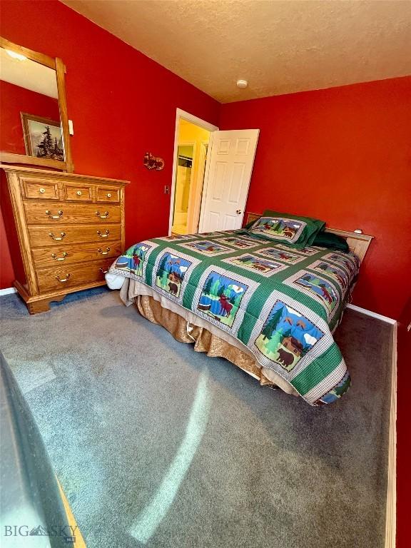 1364 Mcclellan Rd, West Yellowstone, MT 59758 - carpeted bedroom with a textured ceiling