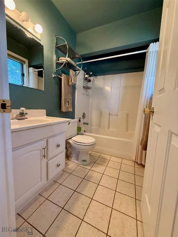 1364 Mcclellan Rd, West Yellowstone, MT 59758 - bathroom with tile patterned flooring, vanity, and shower / bath combo