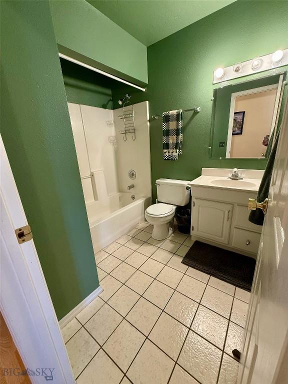1364 Mcclellan Rd, West Yellowstone, MT 59758 - full bathroom with vanity, tile patterned floors, and tub / shower combination