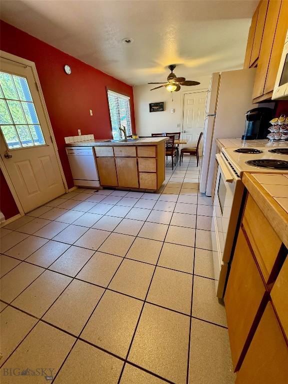 1364 Mcclellan Rd, West Yellowstone, MT 59758 - kitchen featuring white appliances, light tile patterned floors, and a ceiling fan