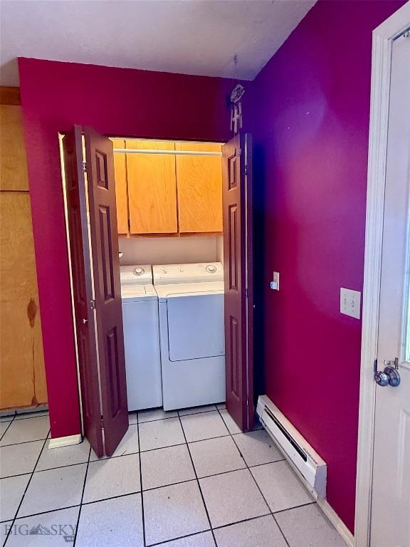 1364 Mcclellan Rd, West Yellowstone, MT 59758 - washroom with a baseboard radiator, cabinet space, separate washer and dryer, and light tile patterned floors