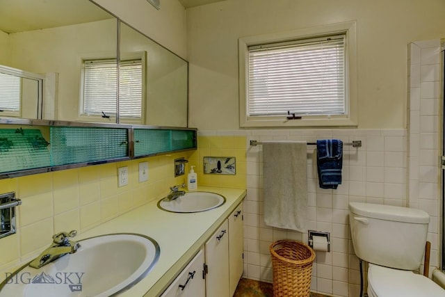511 W Babcock, Bozeman, MT 59715 - bathroom featuring tile walls, double vanity, a shower, and wainscoting