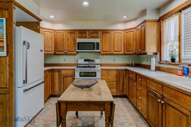 511 W Babcock, Bozeman, MT 59715 - kitchen with white appliances, brown cabinets, light countertops, recessed lighting, and light flooring