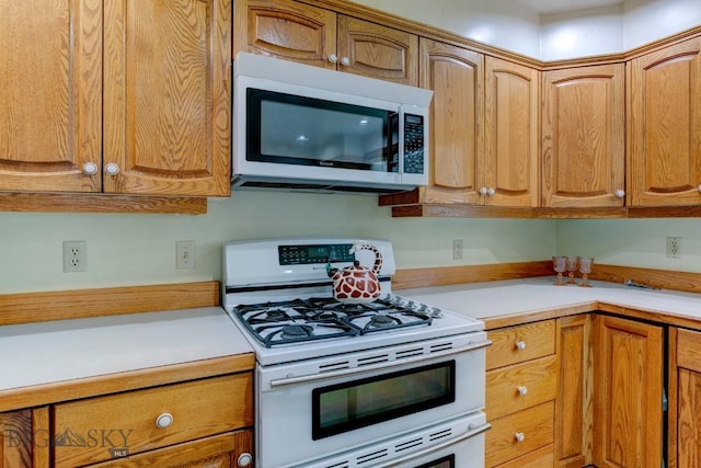 511 W Babcock, Bozeman, MT 59715 - kitchen with white appliances, light countertops, and brown cabinets