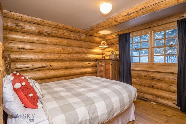 49824 Gallatin Rd, Big Sky, MT 59730 - bedroom featuring wood finished floors and rustic walls
