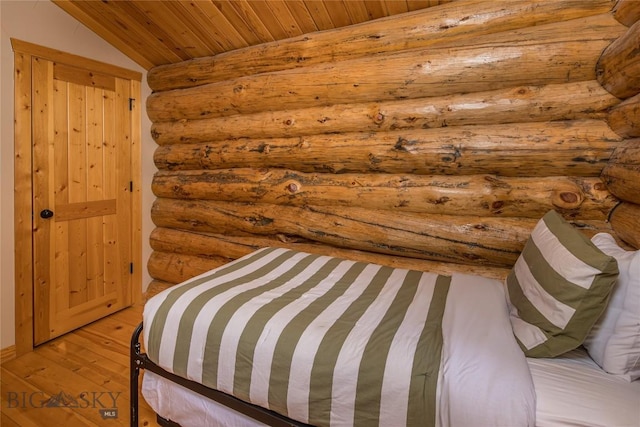 49824 Gallatin Rd, Big Sky, MT 59730 - bedroom with light wood-style floors, wood ceiling, log walls, and vaulted ceiling