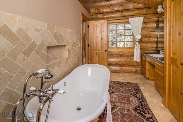 49824 Gallatin Rd, Big Sky, MT 59730 - bathroom featuring rustic walls, a soaking tub, and vanity