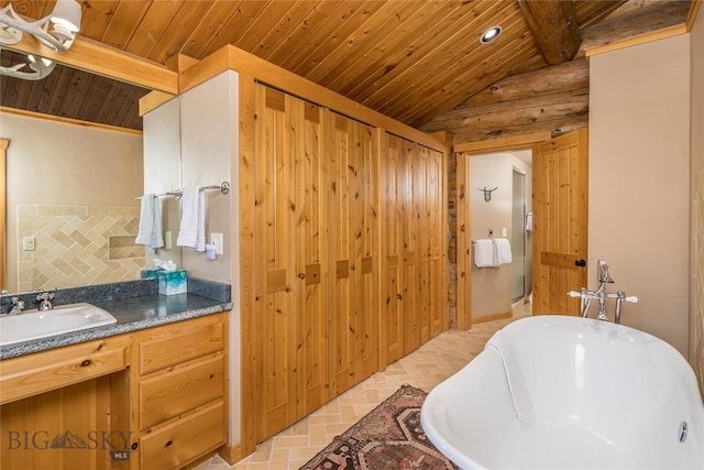 49824 Gallatin Rd, Big Sky, MT 59730 - full bath featuring lofted ceiling, a freestanding bath, wood ceiling, vanity, and brick patterned flooring